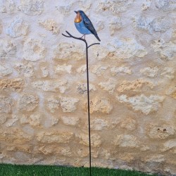 Dekorativer Vogel auf orangefarbenem Spieß