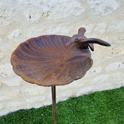 Dekorative Vogeltränke mit kleinem Vogel auf dem Schalenrand