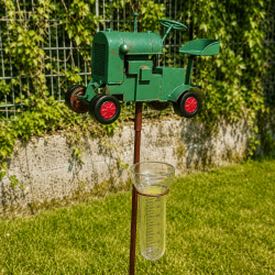 Regenmesser mit grünem Traktor im Garten